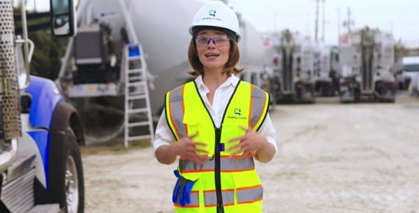 Quality-Crete team member in a hi-vis vest on a jobsite