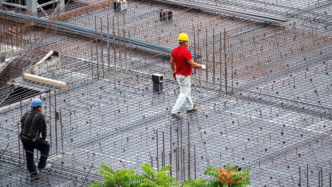 Workers on a rebar mat during a large commercial concrete pour