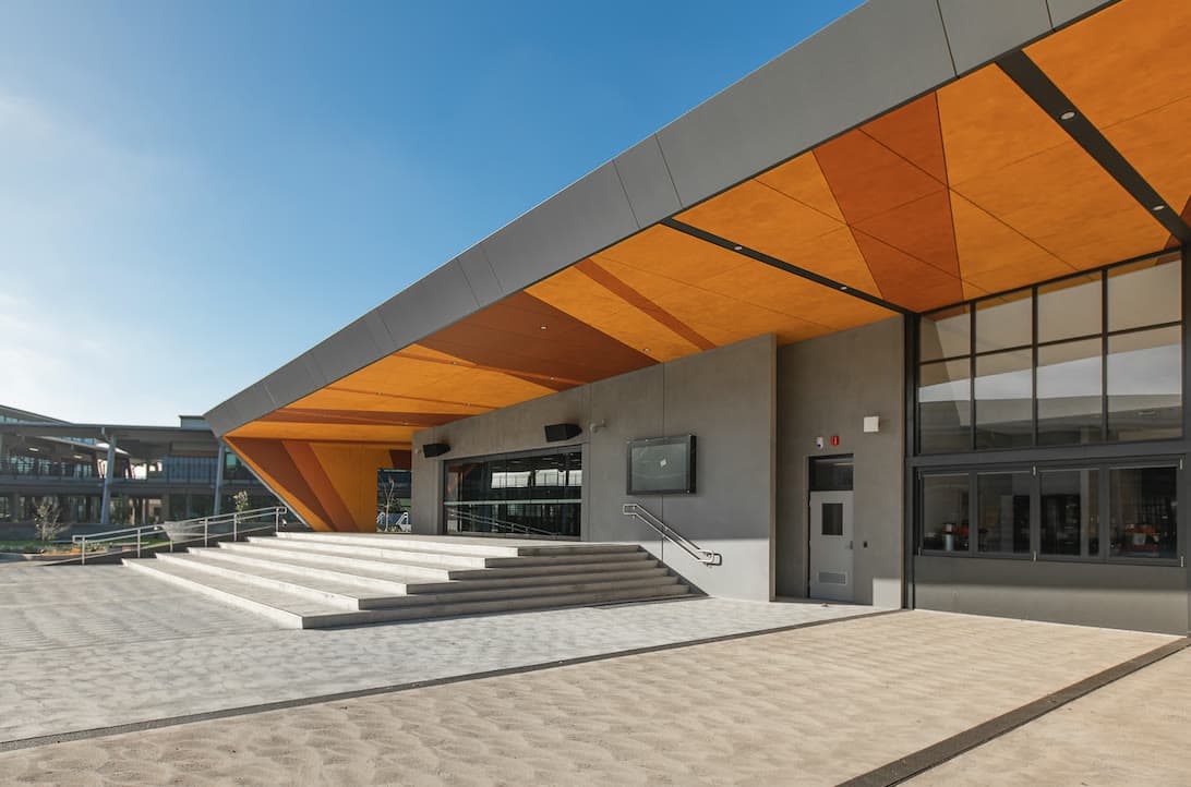 Broom-finished concrete plaza at a modern commercial building entrance