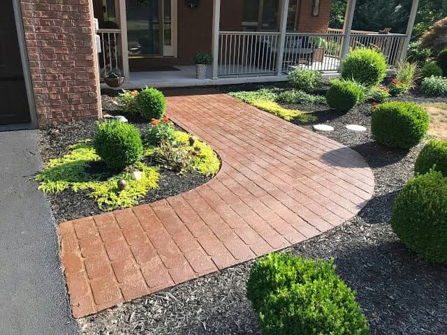 Paver walkway through a landscaped garden