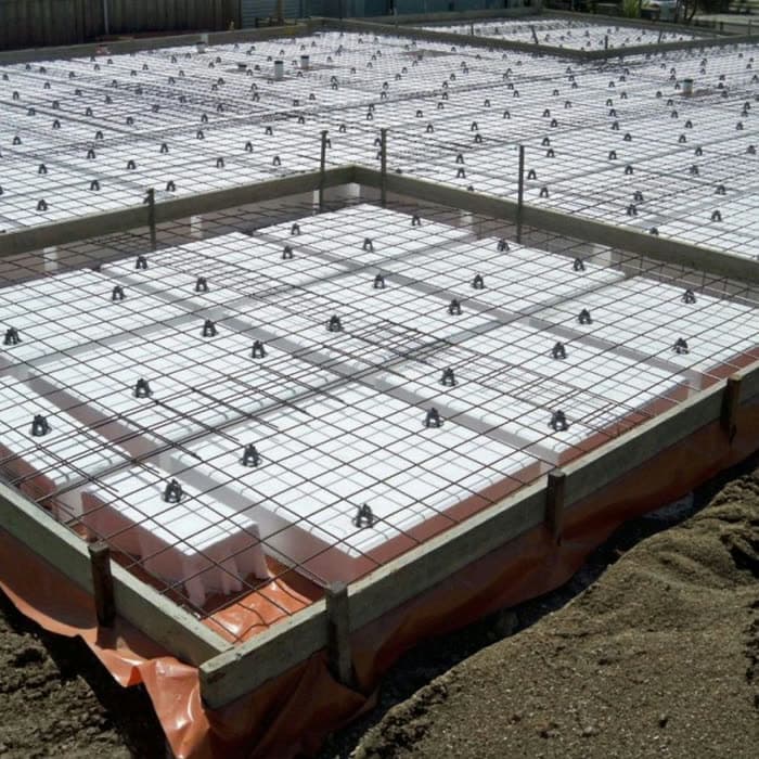 Slab formwork with rebar mat prepared over void-form modules, ready for pour