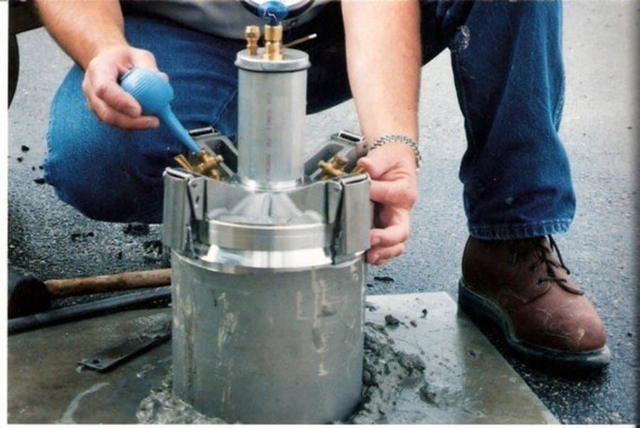 Technician running an air content meter on fresh concrete
