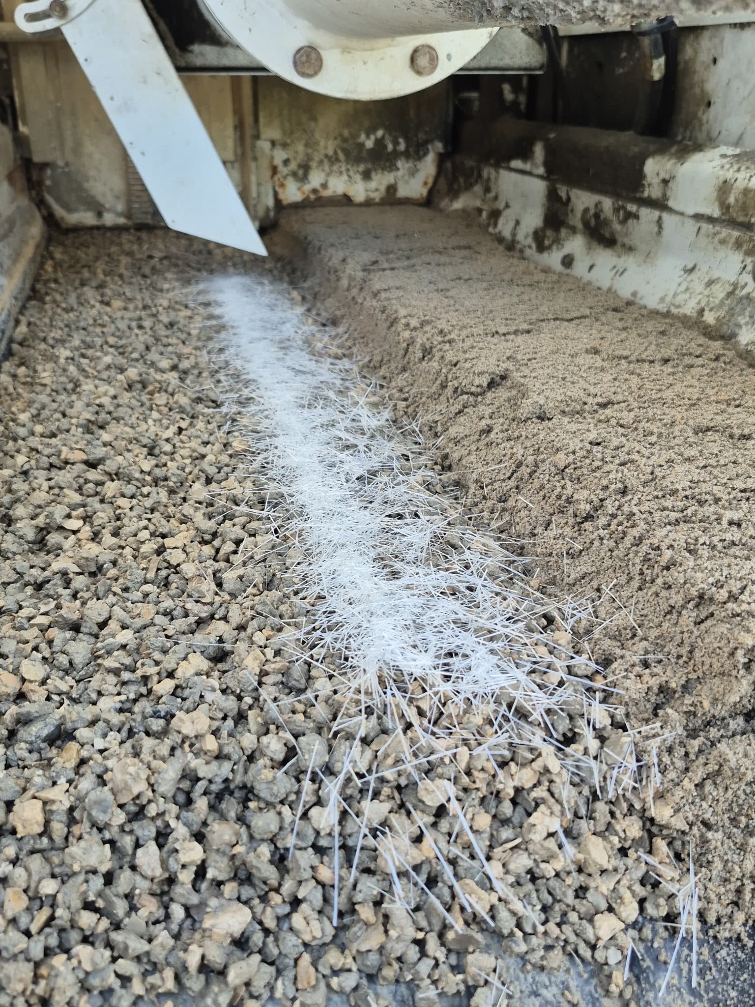 Quality-Crete volumetric mixer producing concrete on a jobsite