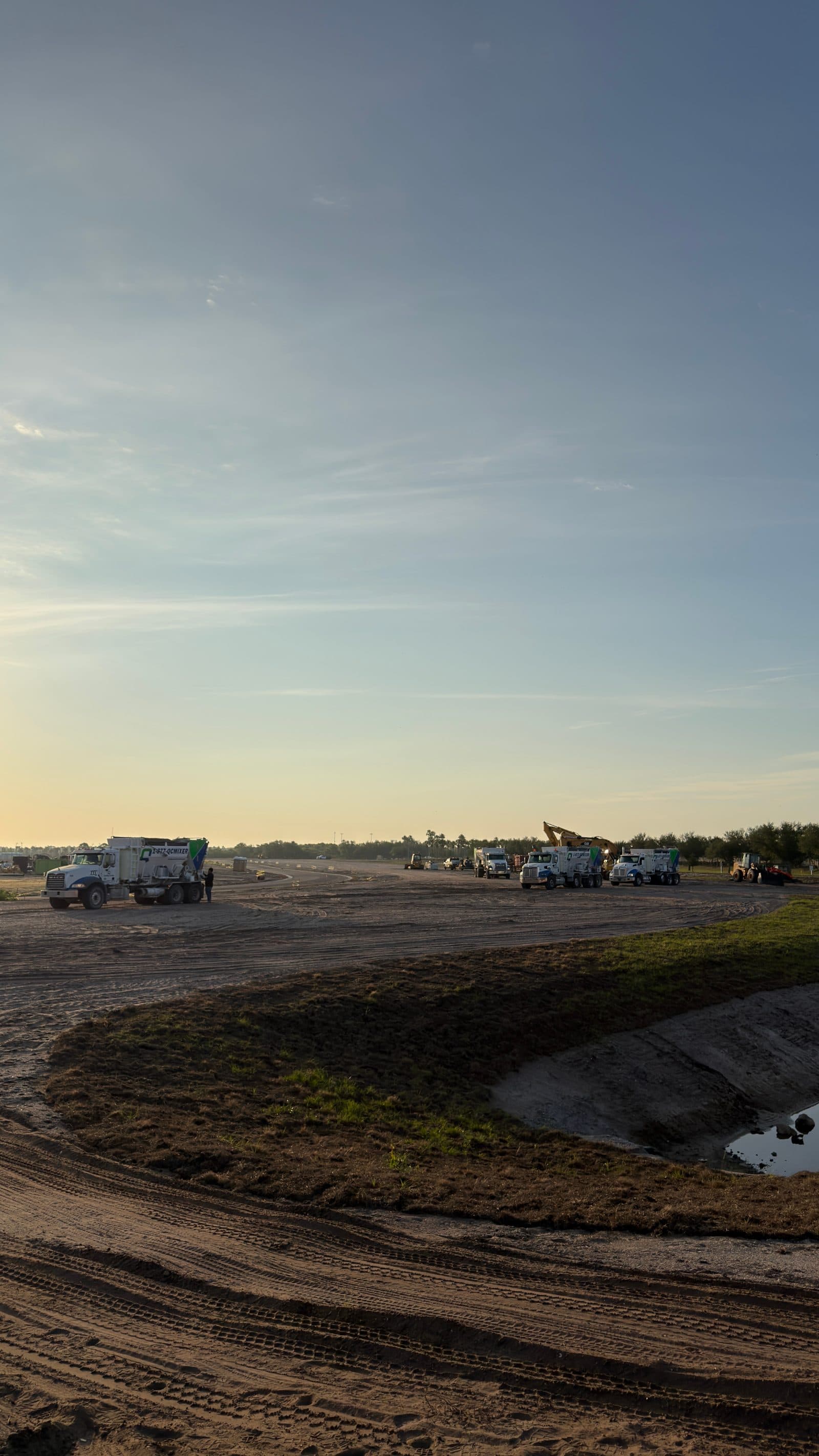 Volumetric mixer on a graded site at sunrise