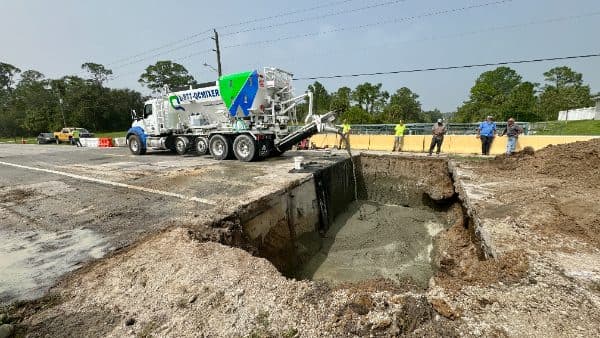 Volumetric mixer placing concrete for site work