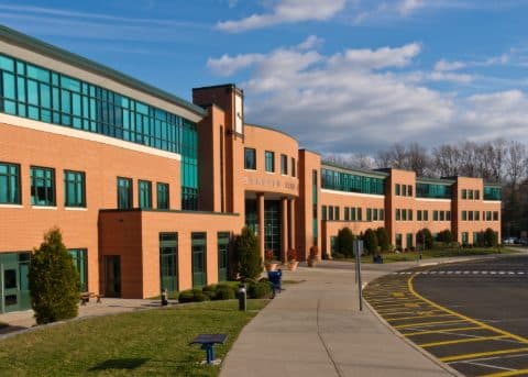 Brick school building with a new concrete walkway