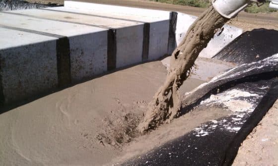 Flowable fill poured into a formed trench