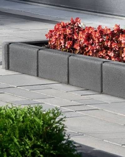 Concrete landscape curbing around a flower bed
