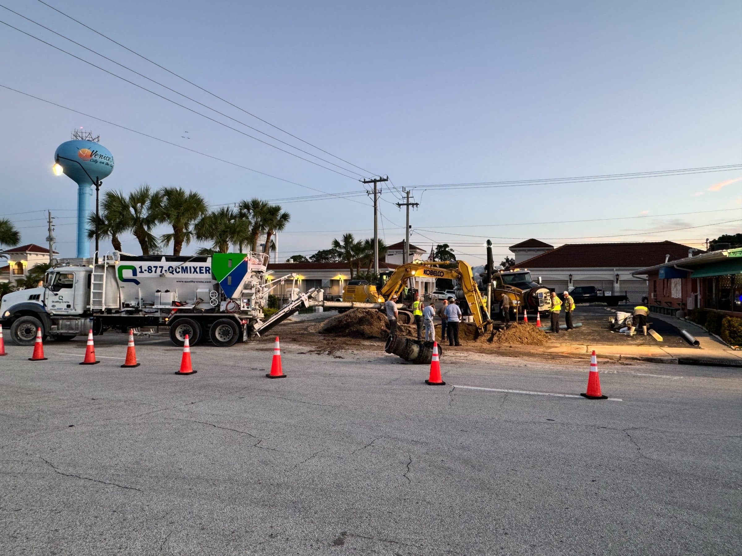 Quality-Crete mixer and crew on a municipal roadway project
