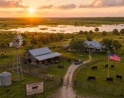 Ranch house and pasture at sunset