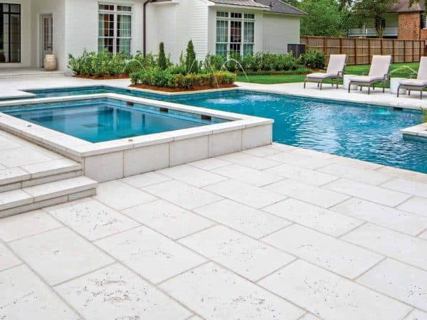 Wide pool deck beside a residential pool